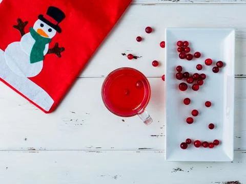 Flat lay. Selective focus on cranberries in a fresh drink in a glass cup. Stock Photos