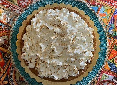 Flat lay on shortbread cake with meringue on a multi-colored napkin Stock Photos