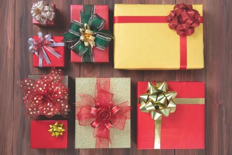 Flat lay shot of coloful boxes with colorful ribbon on wooden background, con Stock Photos