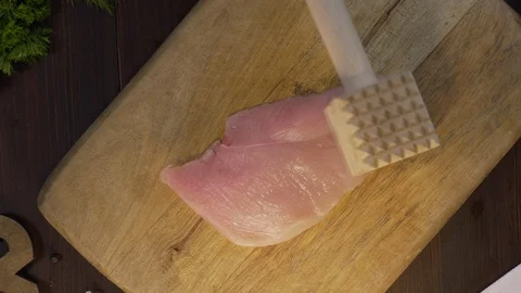 Flat lay shot: the cook makes a chop of chicken fillet on the wooden board, chef Stock Footage 114445472