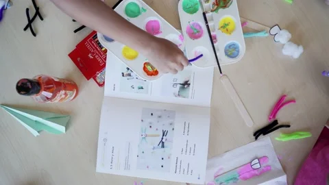 Flat lay shot of kids playing with paper and colours Stock Footage 229777805