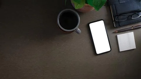 Flat lay smart phone with blank screen, sticky note, coffee cup and books o.. Stock Photos