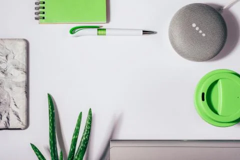 Flat lay of smart speaker with LED lights activated with cropped smartphone Stock Photos