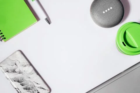 Flat lay of smart speaker with LED lights activated with cropped smartphone Stock Photos