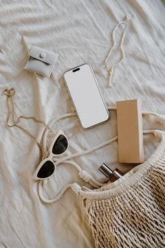 Flat Lay with Smartphone and Accessories on Beige Fabric, Simple Earthy Tones Stock Photos