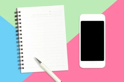 Flat lay of Smartphone, blank notebook and white pen on pastel color blue, gr Stock Photos