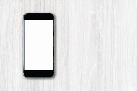 Flat lay Smartphone with blank white screen and copy-space on wood table Stock Photos