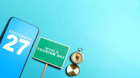 Flat lay of smartphone displaying September 27, a World Tourism Day sign, a.. Stock Photos