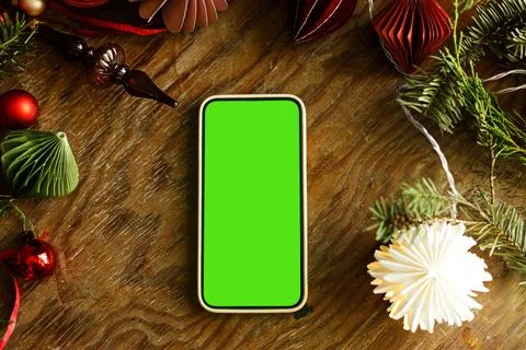 Flat Lay Smartphone with Green Screen Mockup on Wooden Table. Holiday onlin.. Stock Photos