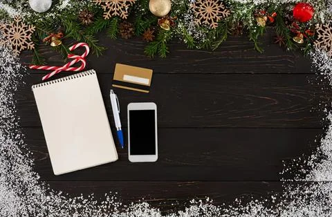 Flat lay of smartphone notebook pen and makeup on black background Stock Photos
