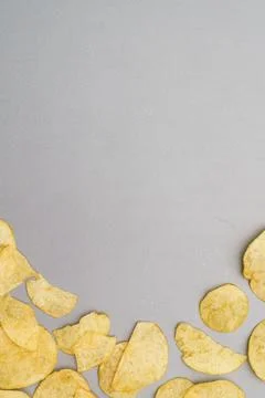 Flat lay of snack, Arrangement of crispy potato chips on gray background Stock Photos