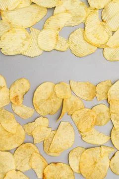 Flat lay of snack, Arrangement of crispy potato chips on gray background Stock Photos