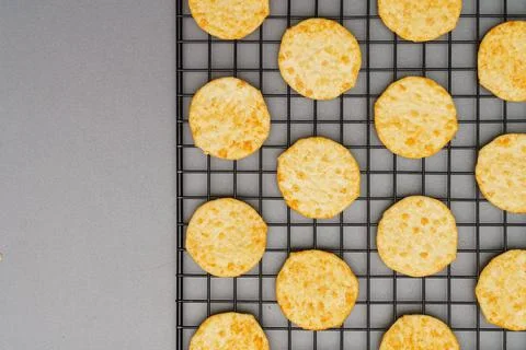 Flat lay of snack, Crispy potato chip arrange on rack oven baked over gray ba Stock Photos