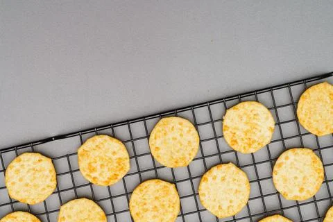 Flat lay of snack, Crispy potato chip arrange on rack oven baked over gray ba Stock Photos