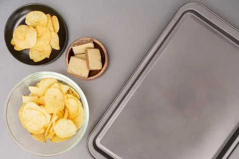Flat lay of snack, Crispy potato chip and wafer in various containers with pl Stock Photos