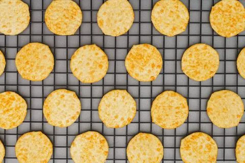 Flat lay of snack, Crispy potato chip arrange on rack oven baked over gray ba Stock Photos