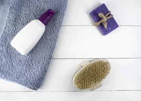Flat lay spa bath on white wooden background, top view products for hygiene. Stock Photos