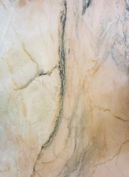 Flat lay of Spanish marble with a deep grey vein splitting cream and light .. Stock-Fotos