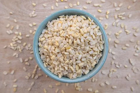 Flat Lay of Split Dehusked Black Gram (Matpe Beans) White Lentils in a Blue Bowl Stock Photos