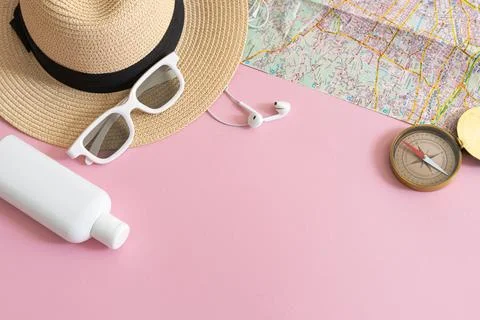 Flat lay with straw hat, spf cream, sunglasses and compass, summer vacation.. Stock Photos