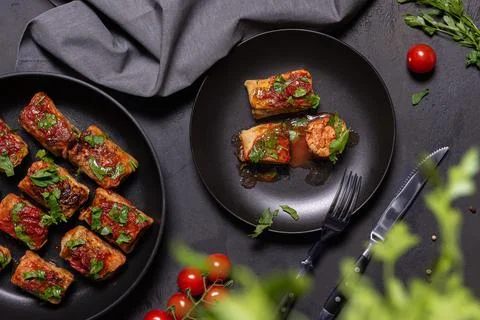 Flat lay with stuffed cabbage rolls and ingredients on white background Stock Photos