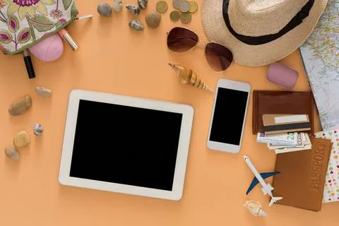 Flat lay of summer accessories and tech on wooden table Stock Photos