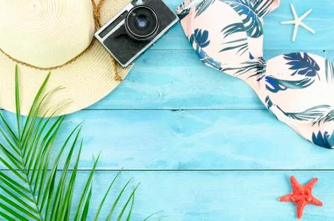 Flat lay summer background with plam leafs, starfishes and bikini on wooden Stock Photos