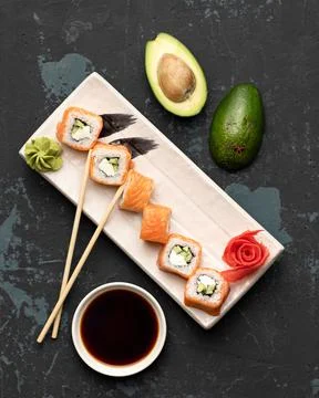 Flat lay, Sushi Set on black background. Philadelphia rolls with salmon and Stock Photos