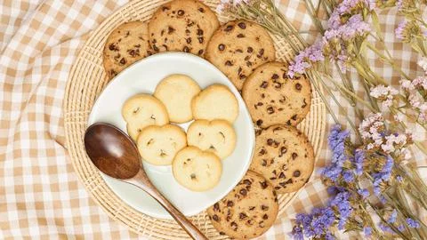 Flat lay of sweets, Butter cookie and chocolate chip cookie in container on b Stock Photos