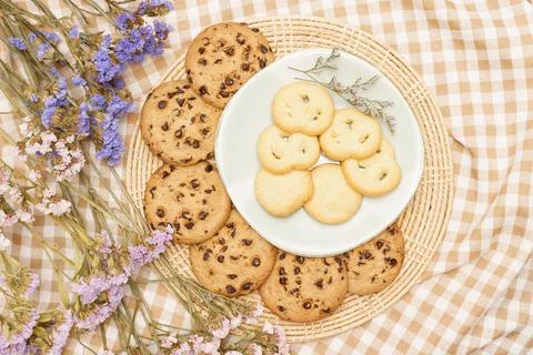 Flat lay of sweets, Butter cookie and chocolate chip cookie in container on b Stock Photos