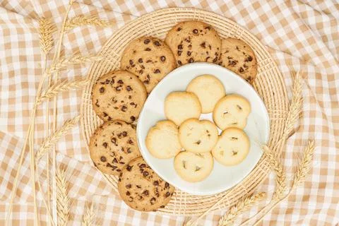 Flat lay of sweets, Butter cookie and chocolate chip cookie in container on b Stock Photos