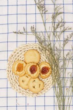Flat lay of sweets, Set of danish butter cookie on rattan plate over blue gin Stock Photos