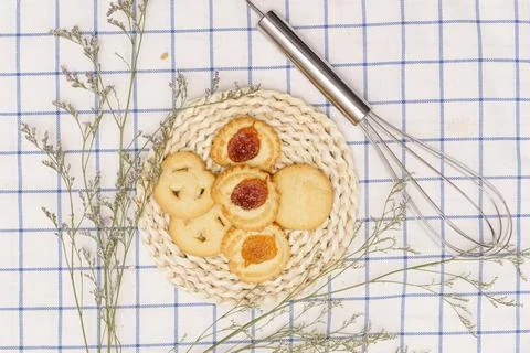 Flat lay of sweets, Set of danish butter cookie on rattan plate over blue gin Stock Photos