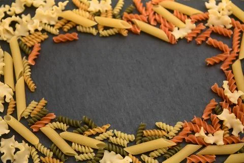 Flat lay of a table with Italian pasta of different varieties and colors (p.. Stock Photos