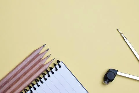 Flat lay, table top view of pencil, compass and Spiral notebook. Office, busi Stock Photos