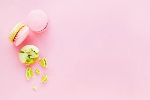 Flat lay with tasty macarons on pink background. Stock Photos