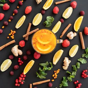 Flat lay. Tea time. Pattern of berries, fruits and herbs, ingredients on black Stock Photos