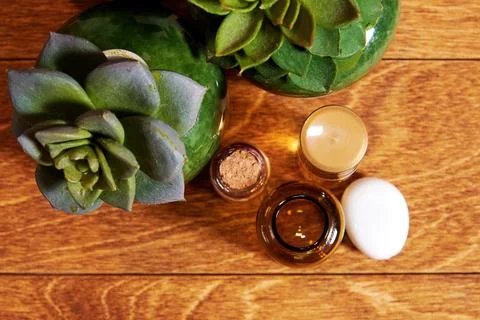 Flat lay template of makeup desk with perfume, cosmetics flasks and succulents Stock Photos