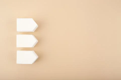 Flat lay with three white make up sponges on pastel beige background with copy Stock Illustration