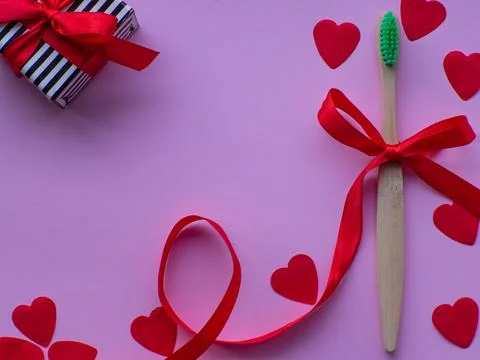 Flat lay with tiny heart-shaped papers, white gift box and space for text Stock Photos