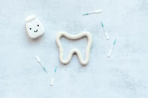 Flat lay of tooth floss with toothpaste, oral care products Stock Photos