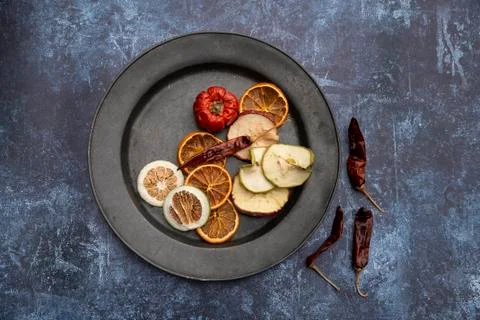 Flat lay top down image of dried seasonal Winter fruit on textured rough back Stock Photos