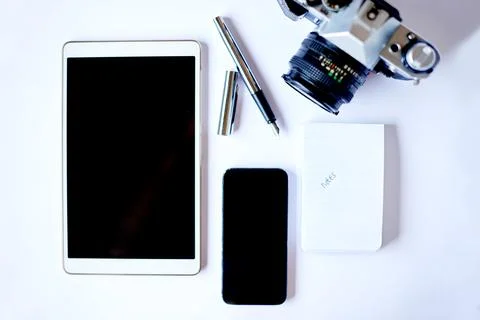 Flat lay, top view and creative tools with camera, notepad and tablet scree.. Foto stock