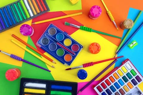 Flat lay top view of art workplace, water colors and crayon pastel chalks Stock Photos