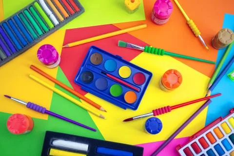 Flat lay top view of art workplace, water colors and crayon pastel chalks Stock Photos