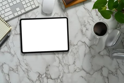Flat lay, top view of digital tablet with empty dimply, coffee cup, notebook and Stock Photos