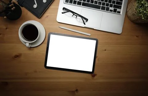 Flat lay, top view. Digital tablet with empty screen, coffee cup and glasse.. Stock Photos