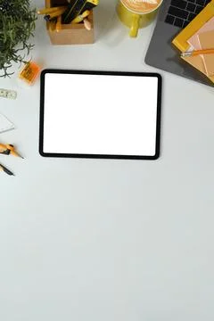 Flat lay, top view digital tablet with white empty screen, coffee cup and laptop Stock Photos