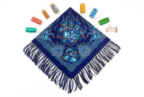 Flat lay top view on folded blue cotton scarf with fringe, paisley and floral Фото
