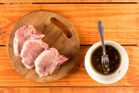 Flat lay top view of fresh pork chops with barbecue marinade in Stock Photos